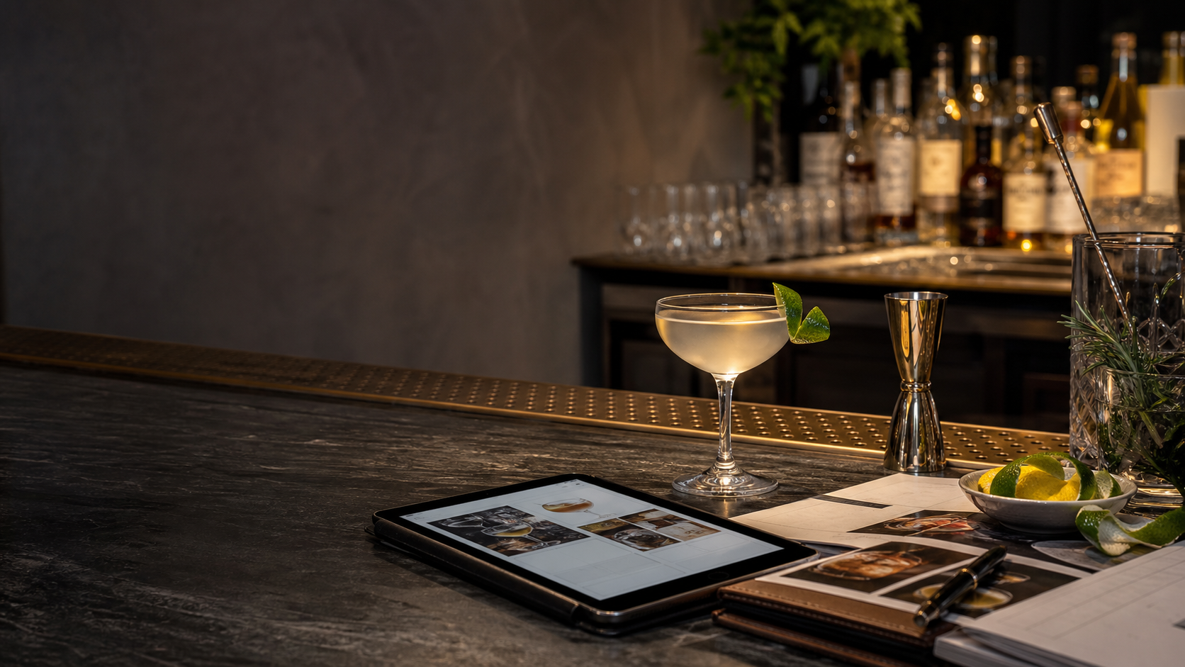 Coupe cocktail on a bar counter with recipe notes nearby